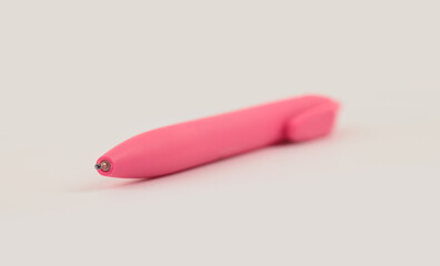 Soft focus blur neon pink color Pen on light beige background..
