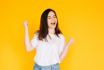 Exultant Woman Celebrating with Fist Raised, Shouting 'Yes' - Victory, Achievement, Success Concept...