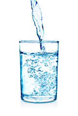 clear water being poured into a glass cup isolated on white background