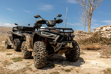 4x4 Quad motorbikes parking offroad in front of a mountain landscape in spring outdoors