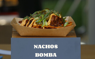 Nachos Bomba, the cheddar nachos, slow smoked and pulled pork with homemade bbq cheddar sauce and...