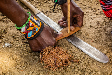 Detail of Masai man making a fire, Kenya