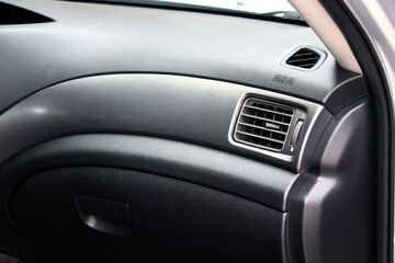 Air vent grill and air conditioning in modern car interior. Passenger airbag car.