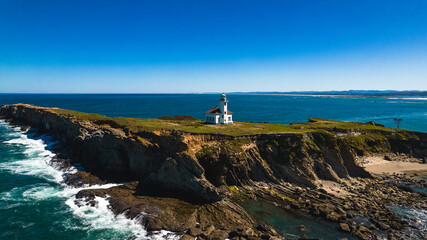 Fototapeta na wymiar Island's Watchtower: A Picturesque Lighthouse Overlooking the Vast Ocean