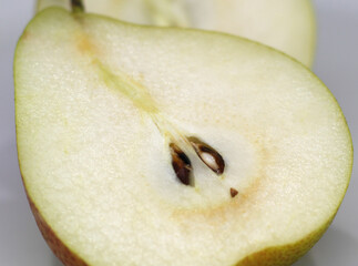 half of pear.  slice of pear. two halves of the pear. pear with selective focus. natural food.