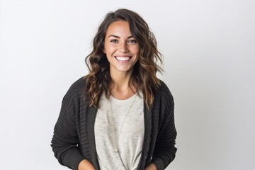 Obraz premium Portrait of smiling young woman standing with hands on hip against white background