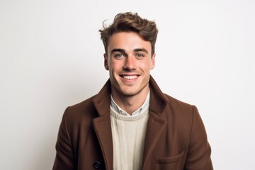 Fototapeta premium Portrait of a smiling young man in coat on white background.