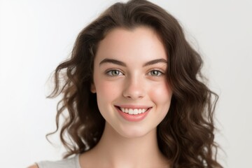 Naklejka premium Portrait of beautiful young woman with long curly hair on white background
