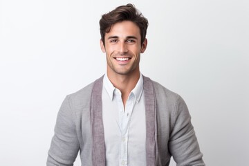 Portrait of a handsome young man smiling while standing against white background