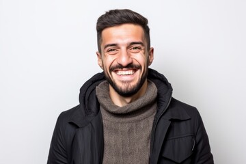 Obraz premium Portrait of a happy young man in winter clothes on white background