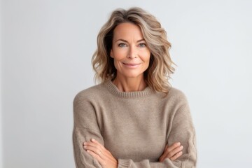 Fototapeta premium Portrait of a middle-aged woman in a sweater on a white background