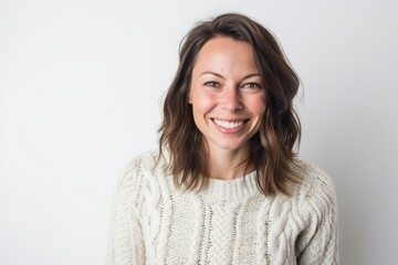 Fototapeta premium Portrait of a young woman smiling at the camera on a white background