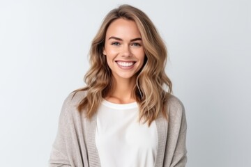 Obraz premium Portrait of a beautiful young woman smiling at camera isolated on a white background