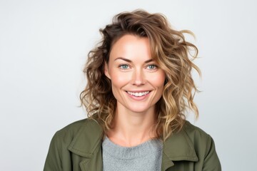 Obraz premium Portrait of a smiling young woman with curly hair against white background