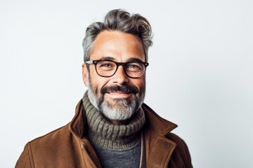 Portrait of a handsome mature man in coat and glasses on white background