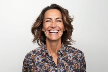 Obraz premium Portrait of a beautiful middle-aged woman smiling against white background