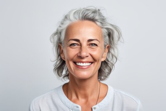 Portrait of a smiling mature woman looking at camera isolated on a white background