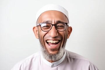 Portrait of a happy middle-eastern muslim man in glasses laughing