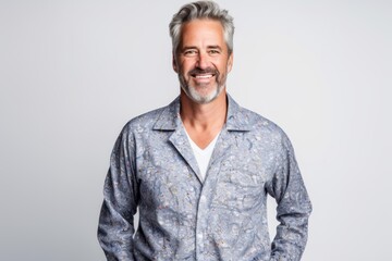 Obraz premium Handsome middle aged man in pajamas on grey background