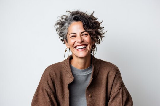 Happy woman laughing and looking at camera isolated on a white background.