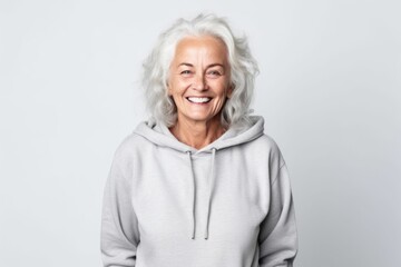 Portrait of a smiling senior woman standing isolated on a white background