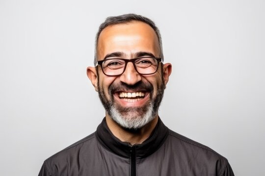 Portrait of a smiling bearded man with glasses on a white background