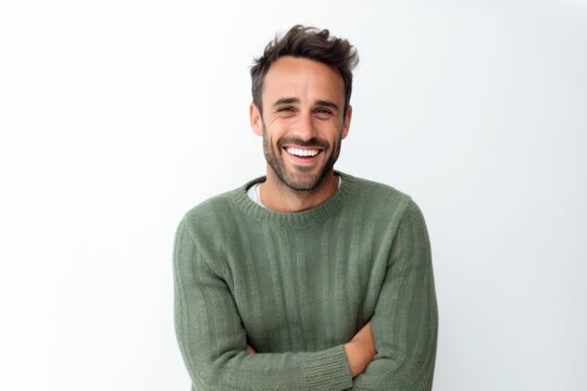 Portrait of a smiling man standing with arms crossed against white background