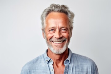 Obraz premium Medium shot portrait photography of a grinning man in his 60s that is wearing a simple tunic against a white background . Generative AI