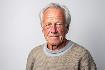 Portrait of an elderly man with grey hair on a white background