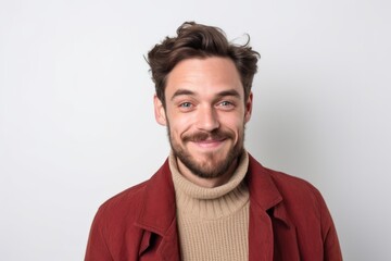 Fototapeta premium Portrait of a handsome young man in a red coat on a white background