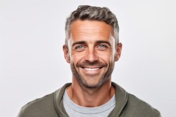 Close up portrait of a handsome mature man smiling and looking at camera over white background