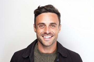 Portrait of a happy young man smiling at camera on white background