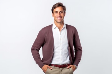 Fototapeta premium Portrait of a handsome young man standing with hands in pockets on white background