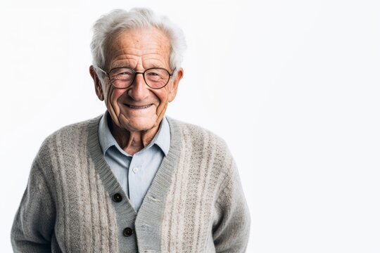 Lifestyle portrait photography of a pleased man in his 80s that is wearing a chic cardigan against a white background . Generative AI