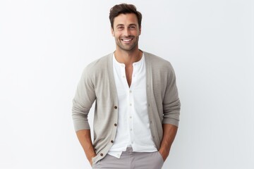 Portrait of good-looking young man with bristle in casual clothes, looking at camera and smiling while standing against white background