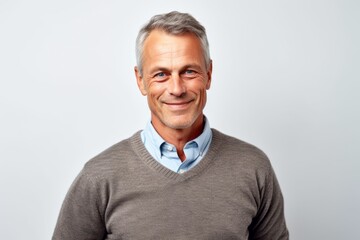 Portrait of a handsome mature man smiling at the camera on a white background