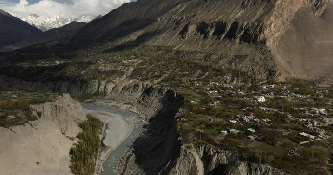 Stuning  aerial view of Gilgit Baltistan, Pakistan, this stock footage takes you through the majestic mountains, river, and villages of the Hunza Valley in the Karakoram range of the Himalayas