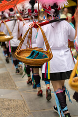 The local Chinese Dong minority people celebrate Guyu festival in Zhaoxing village, Guizhou, China. They have parade on street with household articles and food.
