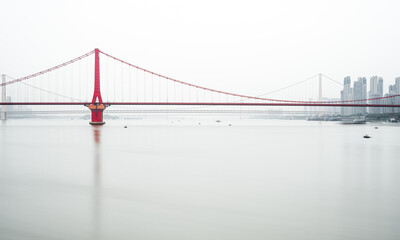 a red steel bridge in the fog
