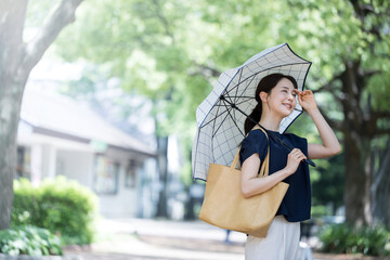 UV protection Beautiful Asian woman looking up with parasol　 © kapinon