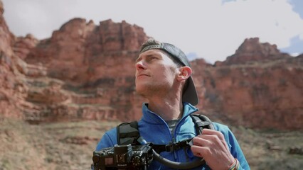Profile hero shot of a man taking in his surroundings and feeling accomplished and free during a hike in the Grand Canyon