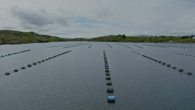 Drone flying low over fish farm in Kenmare Bay West Cork Ireland on a May Morning