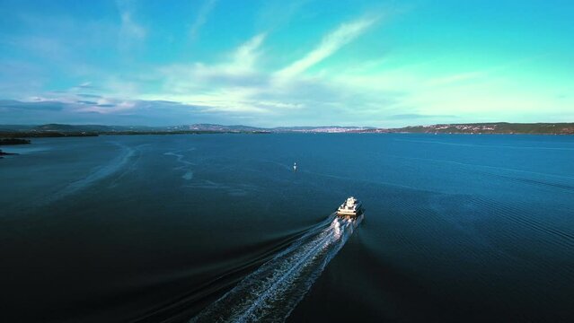 Aerial view following a ferryboat on the Oslofjord sea, spring evening in Norway