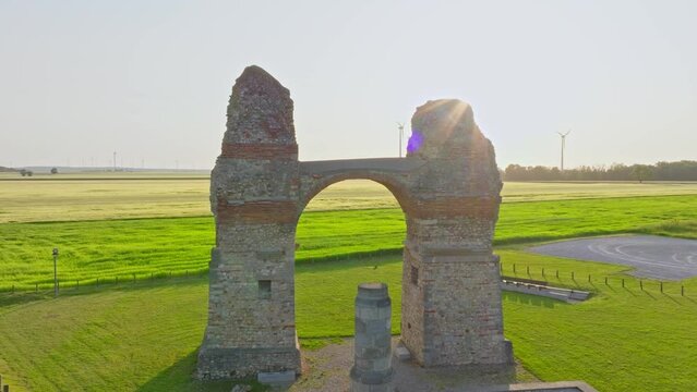 Old Roman Gate Heidentor At Sunset In Carnuntum, Austria - aerial pullback