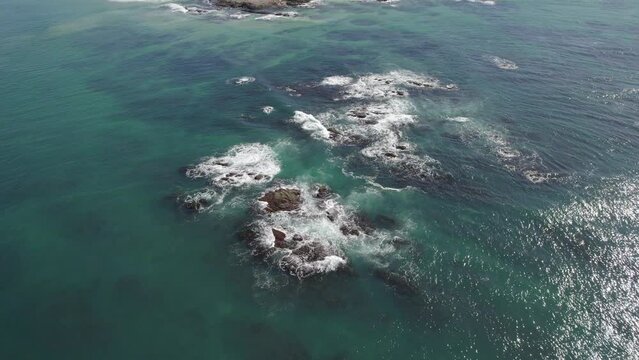 Waves Splashing On The Beach In Wenonah Head, Urunga, NSW, Australia - aerial drone shot