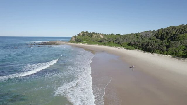 Tourists Walking On The Scenic Coast Of The Beach In Wenonah Head, Urunga, NSW, Australia - aerial drone shot