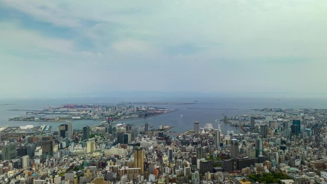 Time Lapse: Clouds move over downtown Kobe City and port area on sunny day