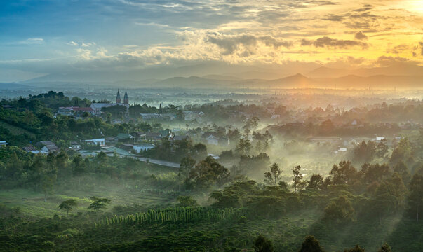 Sun rays at the valley on Bao Loc town. The far side is Thanh Xa Church in Lam Dong province, Vietnam.