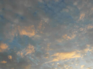 Clouds in the blue sky at sunset as an abstract background.