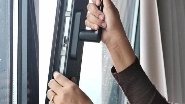 hand open gray plastic pvc window at home at early morning 